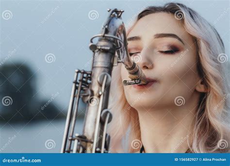 Portrait Of Young Musician On Nature Background Woman Face Playing