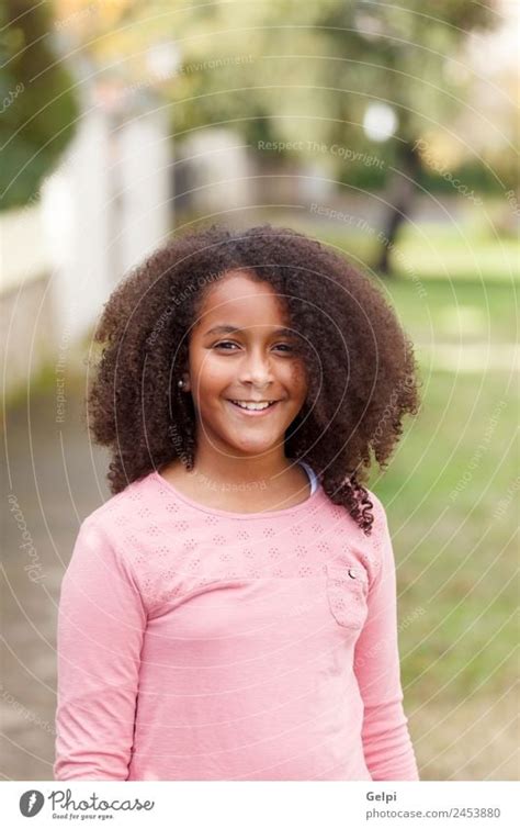 Cute African American Girl Smiling In The Street With Afro Hair A