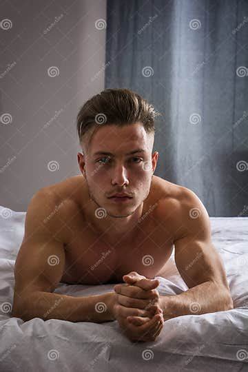 shirtless male model lying alone on his bed stock image image of inviting shirtless 72382717