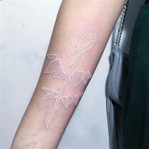 White Rose Tattoo On The Right Inner Forearm