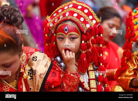 A Young Girl Dressed As The Living Goddess Kumari Reacts During The