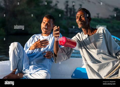 Luxor Egypt November 3 2011 A Pair Of Egyptian Men In Traditional Galbiya Robes Sit At The