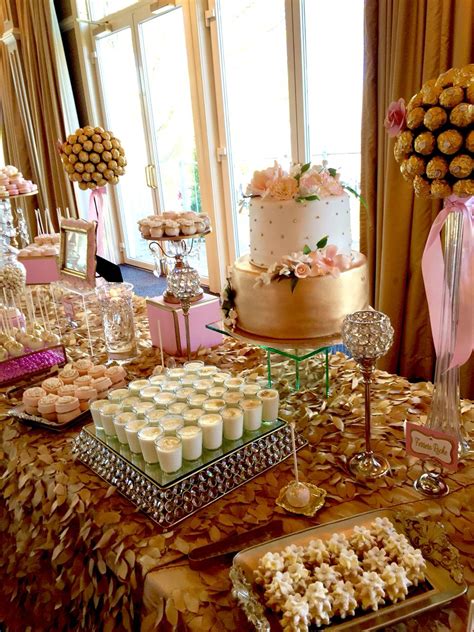 A Table Topped With Lots Of Desserts And Cupcakes On Top Of It