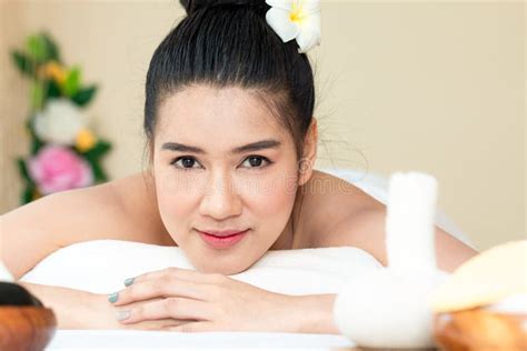 Close Up Of Attractive Young Asian Woman Smiling And Getting Spa