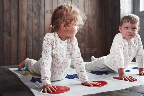 Two Of Happy Children Playing At Twister In House Brother And Sister
