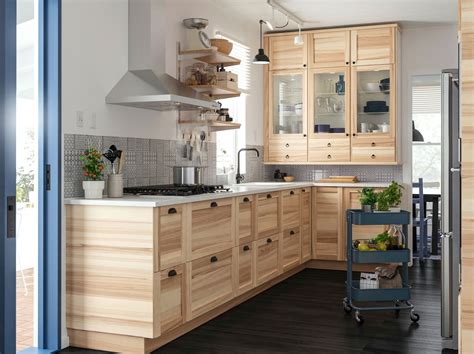 A Kitchen With Wood Fronts And A White Countertop With A Sta 880064b11b25ccc65431c4efe6ff7d28 