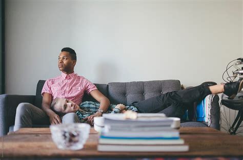 Portrait Of Young Interracial Gay Couple On A Couch By Joselito Briones