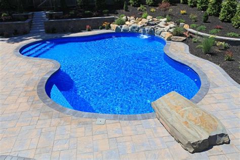 Freeform Pool With Natural Diving Rock And Bright Blue Liner