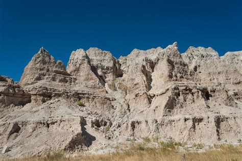Layered Rock Formations Steep Canyons And Towering Spires Of Badlands