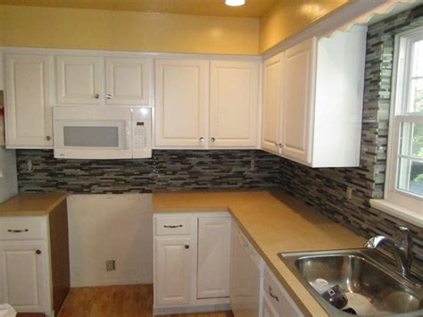 You could also taper your tile or angle your stone backsplash to gradually connect the top to the bottom. Stone and glass mosaic backsplash - wrapped window ...