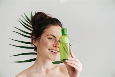 Half Naked Brunette Woman Smiling While Showing Facial Lotion Stock