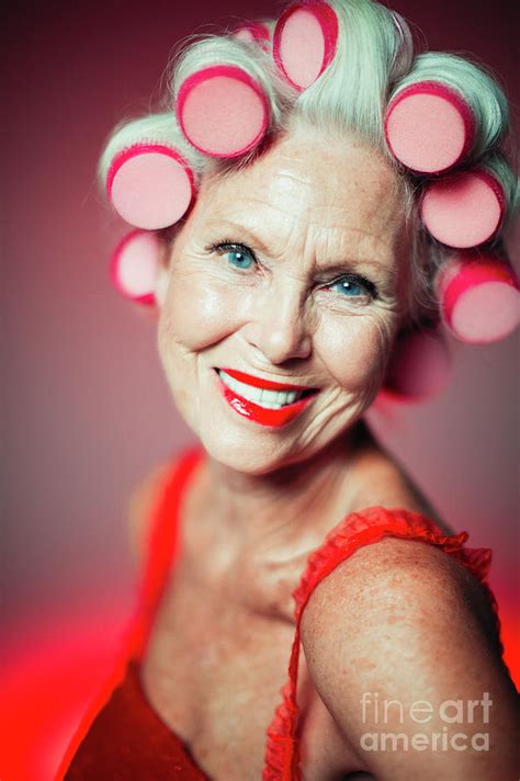 senior woman with hair in curlers photograph by caia image science photo library