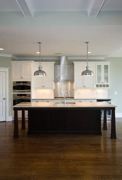 If you have wide cabinet doors on the kitchen worktop and kitchen island, you may need a bigger space between the two to allow the doors to fully open. The standard distance between a countertop and the hood is typically 30 to 36 inches. Some ...