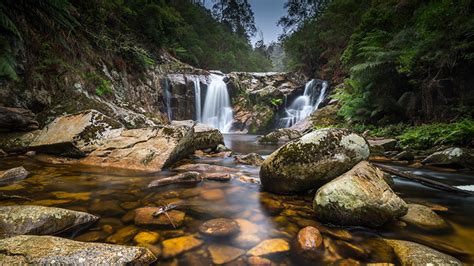 Beautiful Nature Background Waterfalls Stream From Rock Between Green