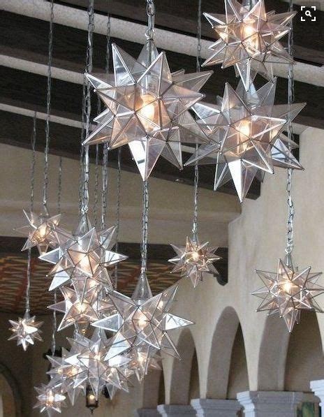 A Chandelier With Stars Hanging From Its Sides And Lights On The Ceiling