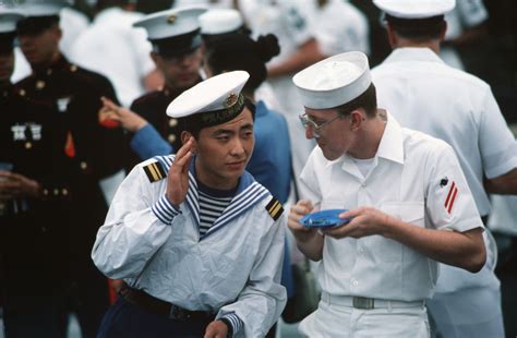 A Chinese Sailor Finds It Hard To Hear The Words Of One Of His American