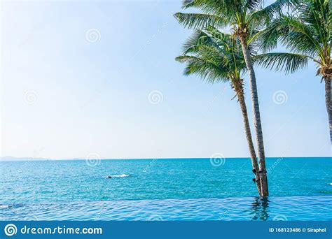 Luxury Outdoor Swimming Pool In Hotel Resort With Coconut Palm Tree