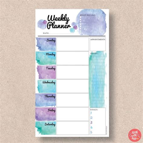 The Weekly Planner Is Shown With Watercolor Paint In Purple Blue And