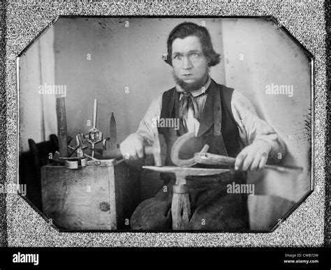 Occupational Portrait Of A Blacksmith Working On A Horseshoe At An