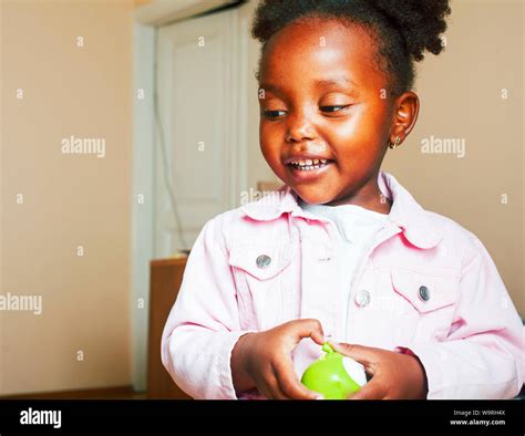 little cute african american girl playing with toys at home pretty adorable princess in