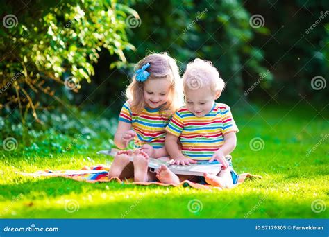 Two Kids Reading In Summer Garden Stock Photo Image 57179305