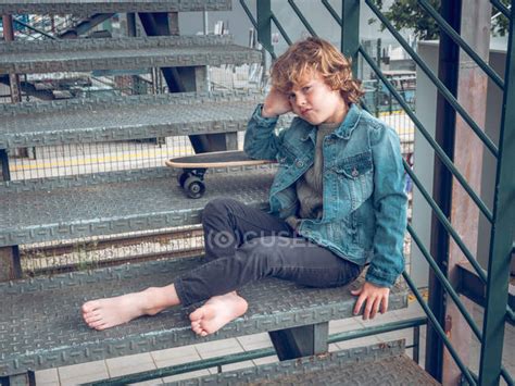 Barefoot Boy Sitting On Stairs With Skateboard — Hobby Motivation