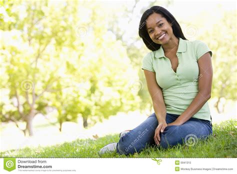 woman sitting outdoors smiling stock image image of twenties outside 5941315