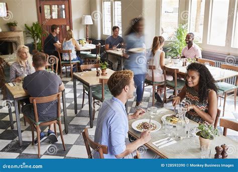 Customers Enjoying Meals In Busy Restaurant Stock Photo Image Of
