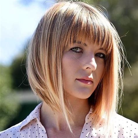 Long A Line Bob With Brow Skimming Fringe Bangs With Blonde Highlights The Latest Hairstyles