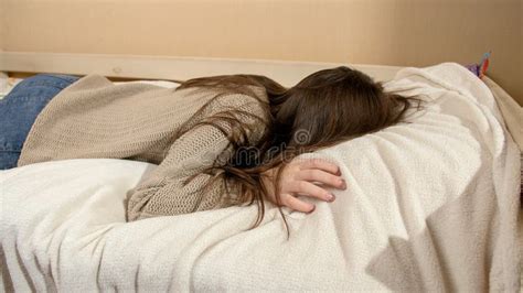 Crying Teenage Girl Jumping On Bed And Lying On Soft Pillow Stock Image
