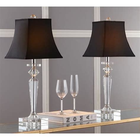 Two Clear Glass Lamps With Black Shades On Each One And A Silver Box