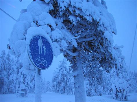 Pedestrians A Snow Covered Road Sign In Ruka Finland Timo Newton