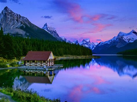 Cabin On Mountain Lake At Sunset