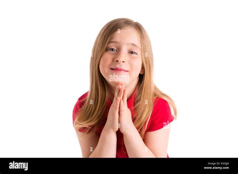 Blond Kid Girl Praying Hands Gesture In White Background Stock Photo