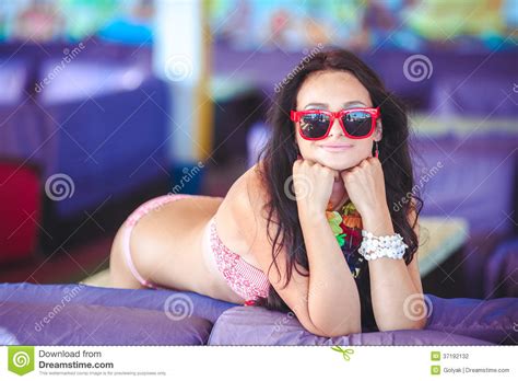 Beautiful Brunette Woman In Bikini Sunbathing On Couch