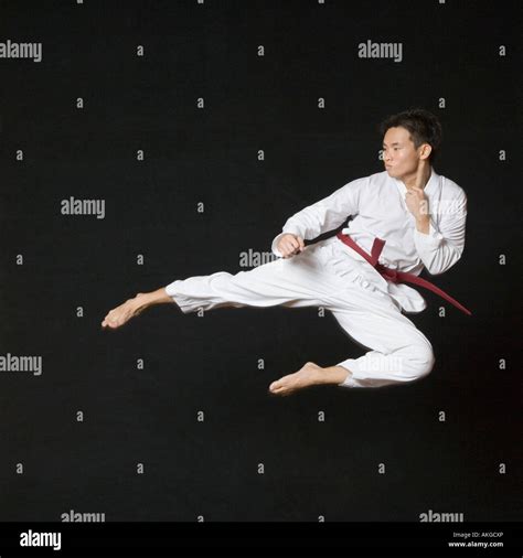 Young Man Performing Flying Kick Stock Photo Alamy