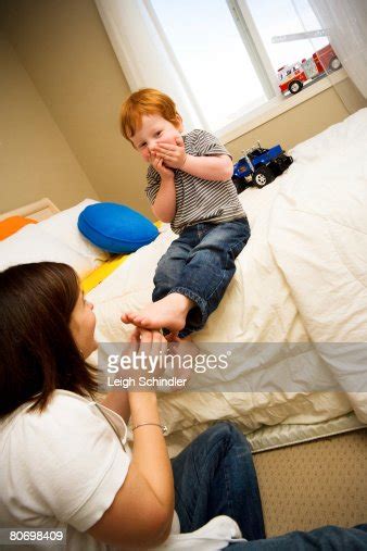 A Mother Tickles Her Sons Feet Photo Getty Images