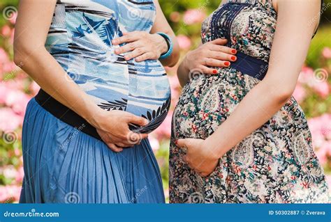 Close Up Of Two Pregnant Bellies Outdoor Stock Image Image Of