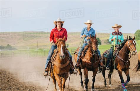 Cowgirls Riding Horses On Ranch Stock Photo Dissolve