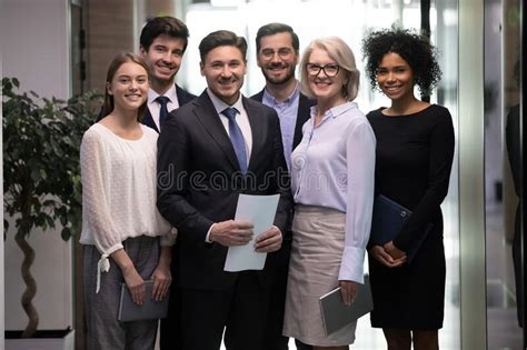 Portrait Of Smiling Multiethnic Employees Posing In Office Stock Image