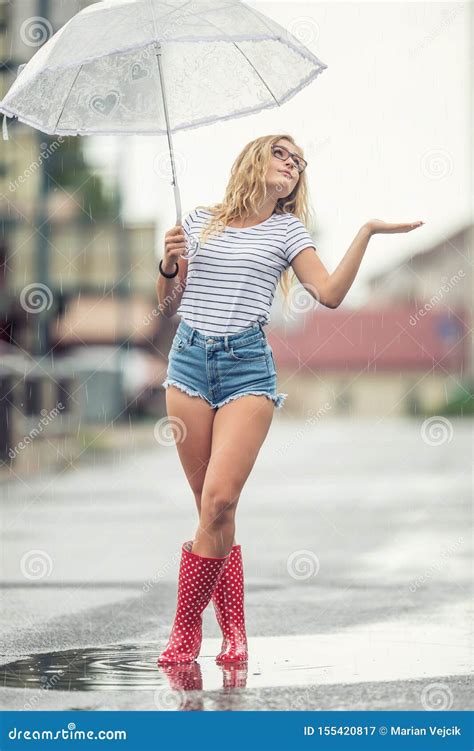 Beautiful Young Blonde Girl Holding Umbrella In Summer Rain Stock Image