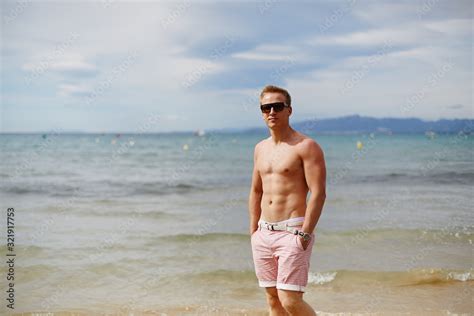 Attractive Shirtless Athletic Young Man On The Beach By The Sea Young