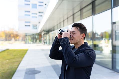 male asian photographer tourist makes photo camera stock image image of shooting