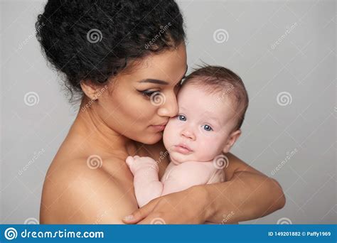 Pretty Woman Holding A Baby In Her Arms Stock Photo Image Of Mothers
