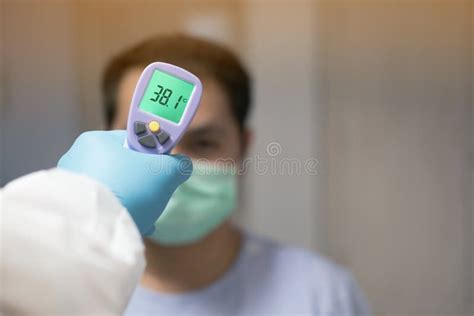 Medical Staff Using A Thermometer Gun Machine Check Body Temperature
