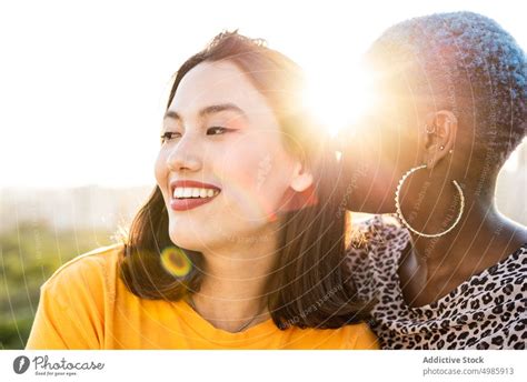 Multi Ethnic Lesbian Couple Hugging Outdoors A Royalty Free Stock