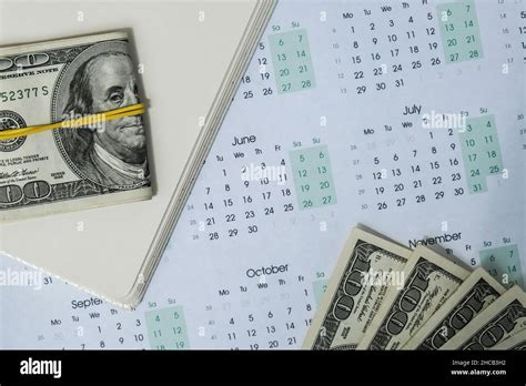 Office workplace desk with dollars and calendar. Counting money for