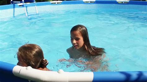 Two Cute Babe Girls Swimming In A Pool Stock Video Footage Dissolve