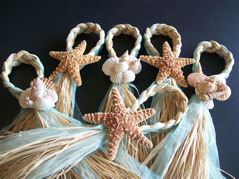 You don't need to decorate the beach for a ceremony but make sure you have a few benches for the people who may need it, like older folks and pregnant guests. Starfish and Raffia Chair Hangers Beach Wedding Decor by ...