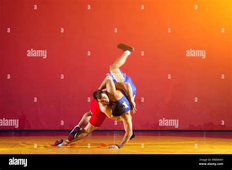 Two Strong Wrestlers In Blue Wrestling Tights Are Wrestlng And Making A
